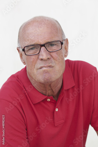 Photo: anxious retired man with red shirt anxious retired man with red shirt