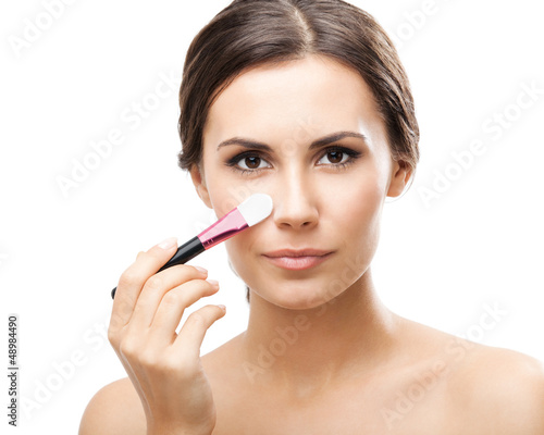 Photo: Smiling woman with make up brush, isolated Smiling woman with make up brush, isolated