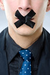 Man with black tape over his mouth