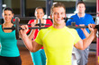 weight training in the gym with dumbbells