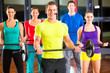 weight training in the gym with dumbbells