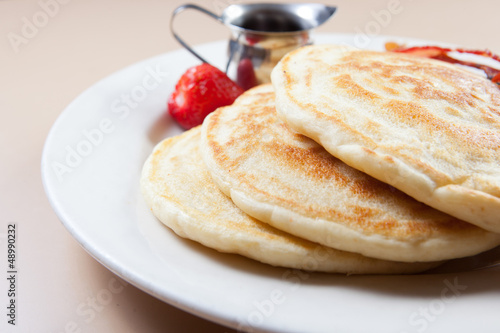 Photo: side view of stack of pancakes with bacon and syrup side view of stack of pancakes with bacon and syrup