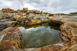 Red stones beach. Rybachy Peninsula. Kola Peninsula. Russia.