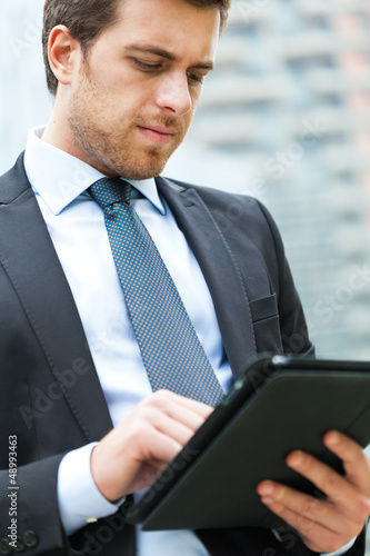 Photo: Businessman using a tablet Businessman using a tablet