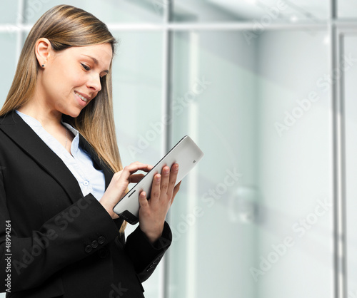 Photo: Businesswoman using electronic tab Businesswoman using electronic tab