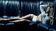 Photo: Beautiful blonde woman on black couch Beautiful blonde woman on black couch
