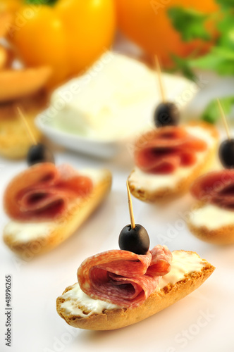 Photo: croutons with sliced salami cheese and olives croutons with sliced salami cheese and olives