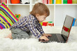 cute little boy and notebook in room