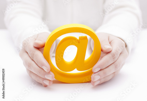 Photo: 3d email symbol protected by hands 3d email symbol protected by hands