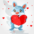Cute little bunny holds a soft red heart-pillow Valentine gift