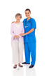 beautiful young nurse and senior woman isolated on white