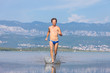 Man run across the beach
