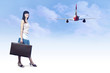 Young woman on the vintage baggage wait on the flying