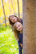 Autumn sister kid girls playing in forest trunk outdoor