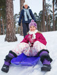 Photo: Girl on sleds in snow Girl on sleds in snow