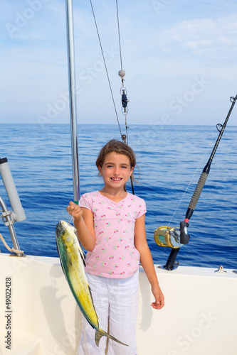 Photo: child girl fishing in boat with mahi mahi dorado fish catch child girl fishing in boat with mahi mahi dorado fish catch