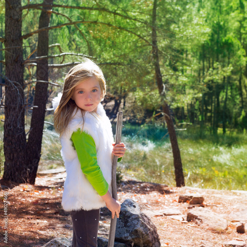 Photo: Explorer blond kid girl sith stick and winter white fur Explorer blond kid girl sith stick and winter white fur