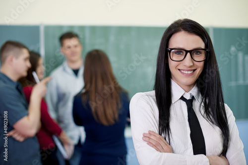 Photo: Beautiful young teacher with students Beautiful young teacher with students
