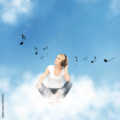 Photo: happy teenage girl in big headphones happy teenage girl in big headphones