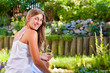 Woman sitting at pond in her garden