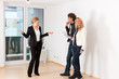 Photo: Young couple looking for real estate with female realtor Young couple looking for real estate with female realtor