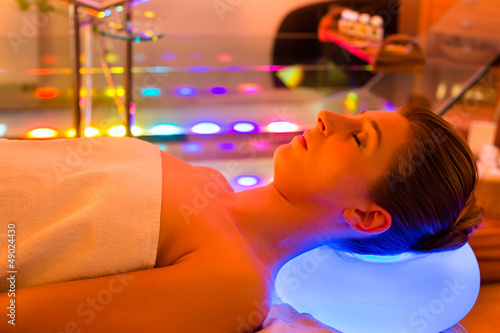 Photo: Woman enjoying therapy in spa with color therapy Woman enjoying therapy in spa with color therapy