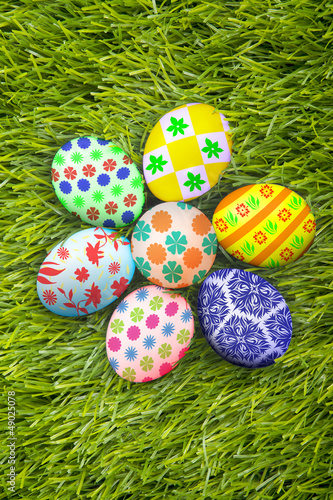 Photo: Easter eggs background on grass Easter eggs background on grass
