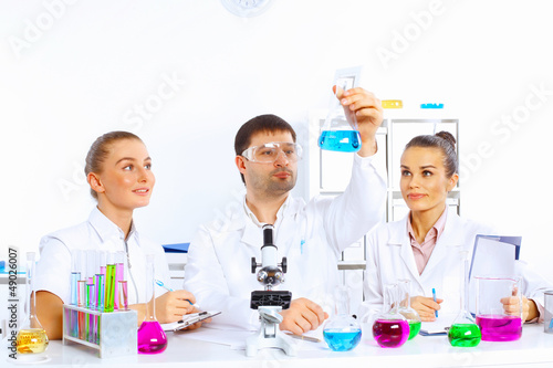 Photo: Team of scientists working in laboratory Team of scientists working in laboratory
