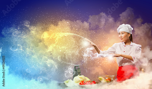 Photo: Asian female cooking with magic Asian female cooking with magic