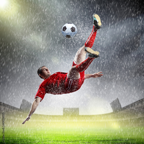 Photo: football player striking the ball football player striking the ball