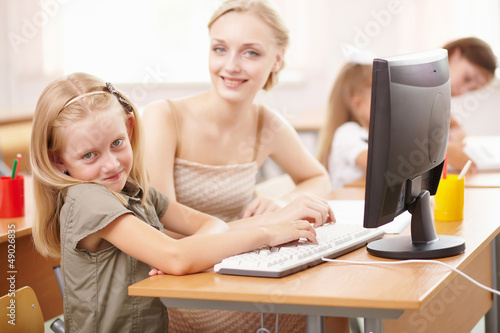 Photo: Little girl at school class Little girl at school class