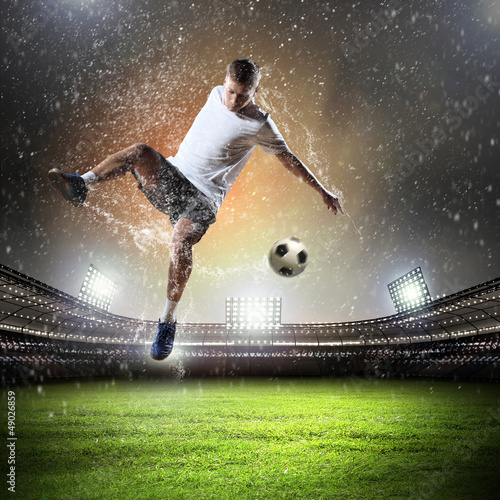 Photo: football player striking the ball football player striking the ball