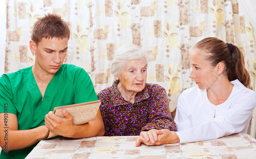 Photo: Elderly woman with the young doctors Elderly woman with the young doctors
