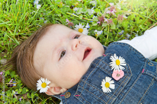 Photo: baby on green grass with daisy baby on green grass with daisy