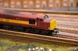 Red and yellow weathered model train diesel engine