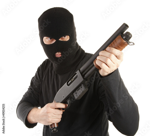Photo: Masked man aims with rifle Masked man aims with rifle