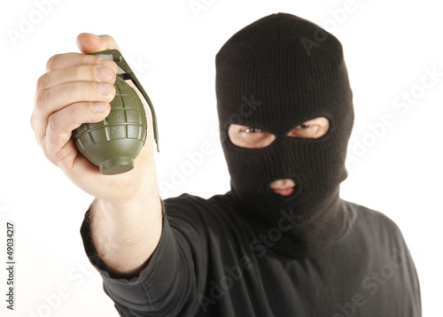 Photo: Masked man bomber aims with hand grenade Masked man bomber aims with hand grenade