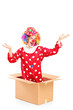 Smiling clown coming out of a cardboard box