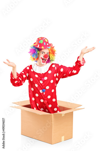 Photo: Smiling clown coming out of a cardboard box Smiling clown coming out of a cardboard box