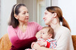  mother gives solace to crying adult daughter