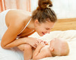 Mother and daughter play in the bedroom