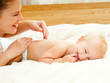 Mother and daughter play in the bedroom