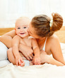 Mother and daughter play in the bedroom