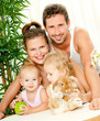 Young happy family with a pet rabbit