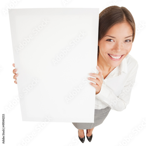 Photo: Woman showing a white board sign poster Woman showing a white board sign poster