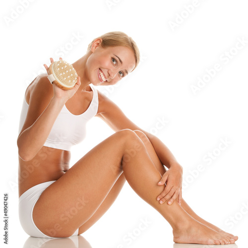 Photo: Woman with massage brush Woman with massage brush