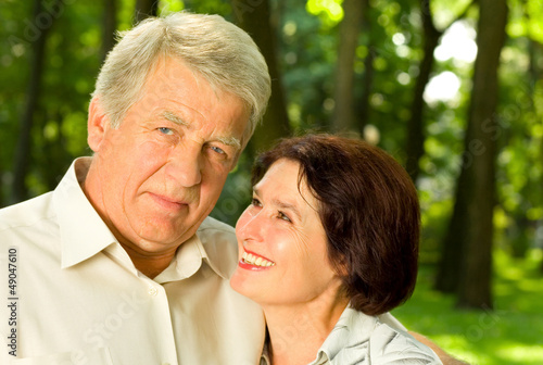 Photo: Senior happy couple embracing, outdoors Senior happy couple embracing, outdoors