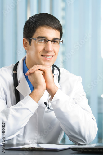 Photo: Portrait of happy doctor at office Portrait of happy doctor at office