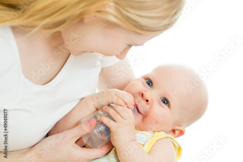 Photo: mother feeding from bottle her adorable baby boy mother feeding from bottle her adorable baby boy