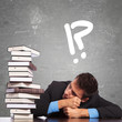 tired law student looking at a big pile of books